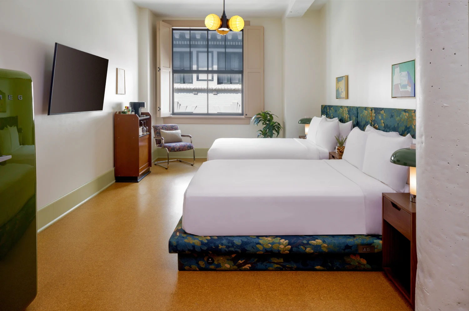 Professional shot of a stylish hotel room featuring two beds and a unique artistic wardrobe
