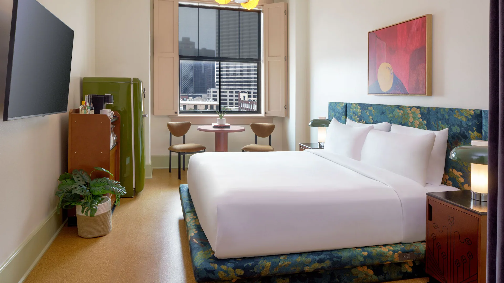 Professional shot of a plush king bed and unique decor in a modern suite at boutique hotels new orleans