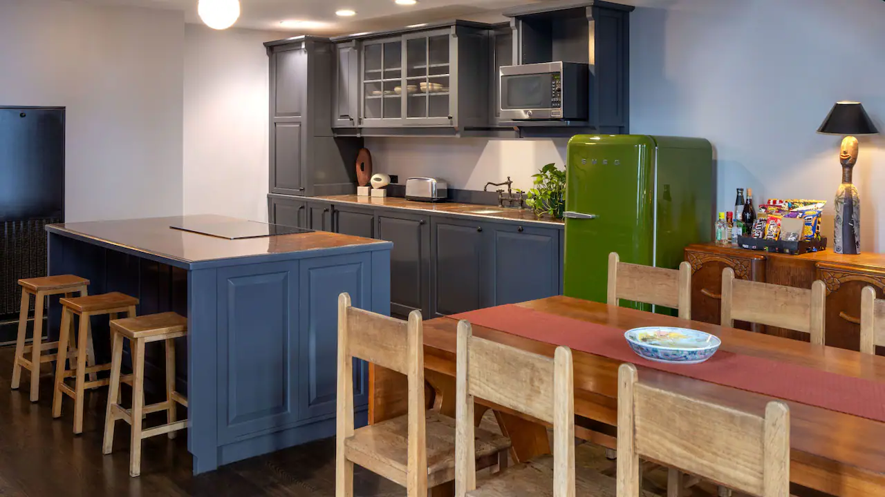 a kitchen with blue cabinets and a green refrigerator