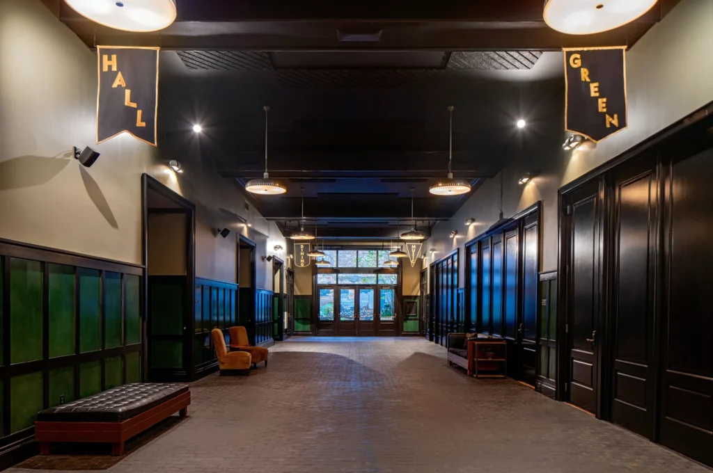 a long hallway with a bench and lights
