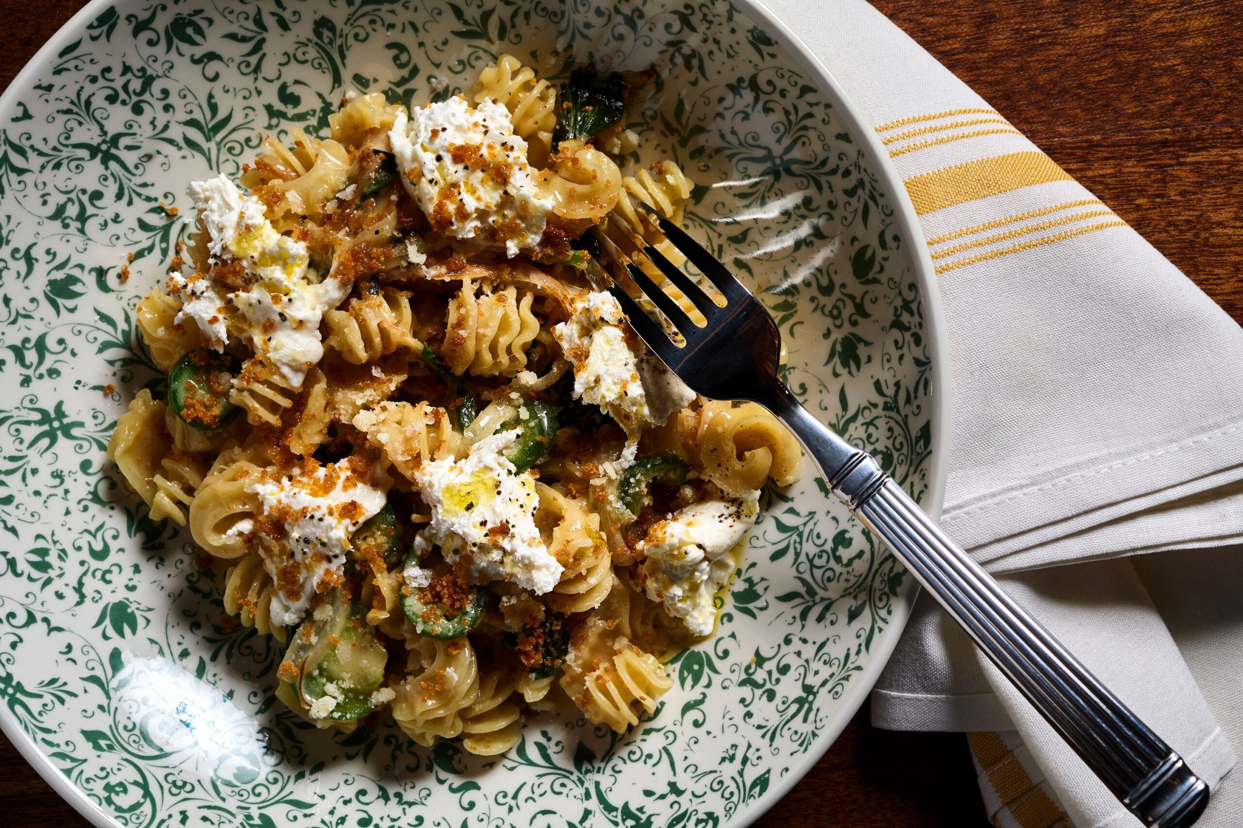 Professional shot of cavatappi pasta topped with creamy ricotta and crunchy breadcrumbs