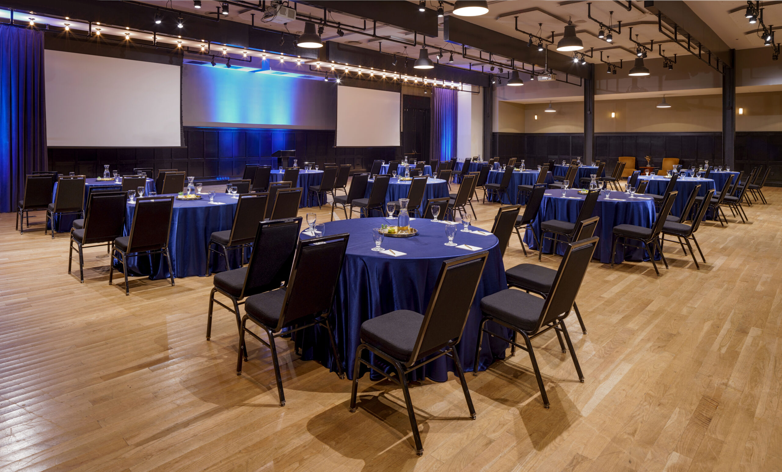 Elegant hotel ballroom set with blue-draped tables, perfect for hotel wedding venues in New Orleans