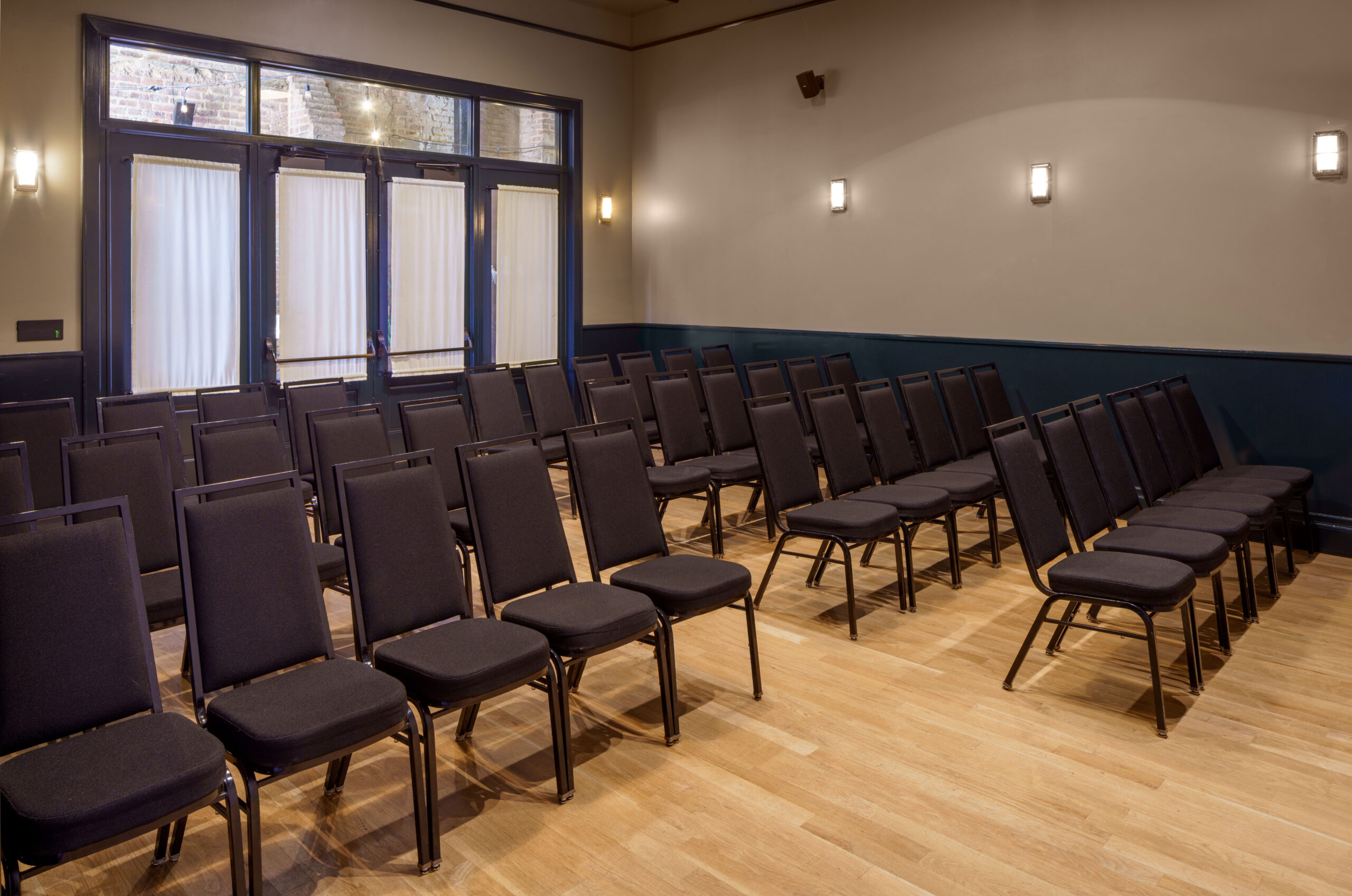 Elegant event room at The Barnett set up for a presentation or ceremony, ideal for hotel wedding venues in New Orleans