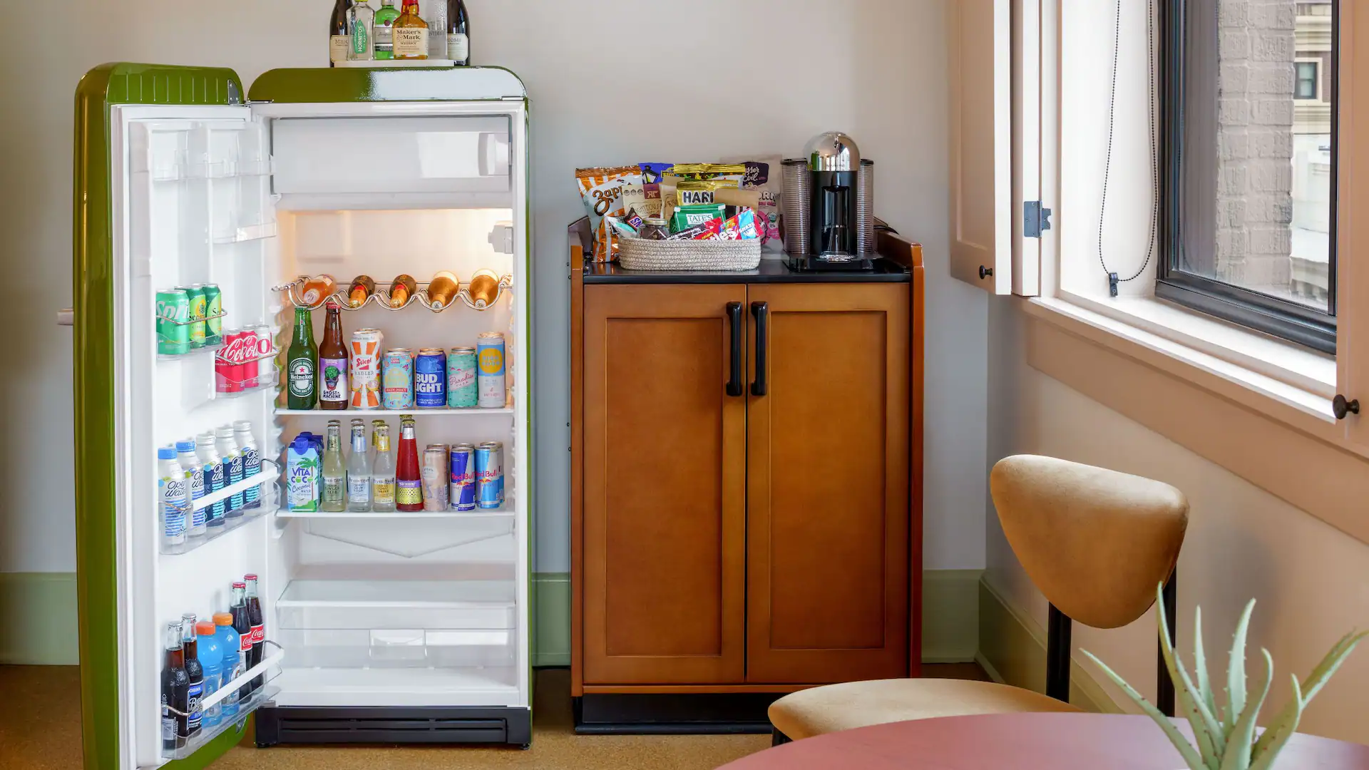 Detailed close-up showing a fully stocked retro green mini-fridge and coffee station