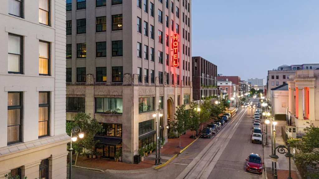 a city street lined with tall buildings and parked cars