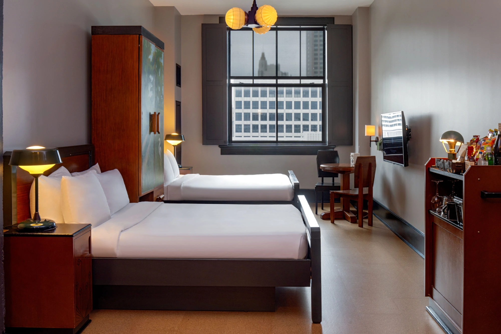 a hotel room with two beds and a desk