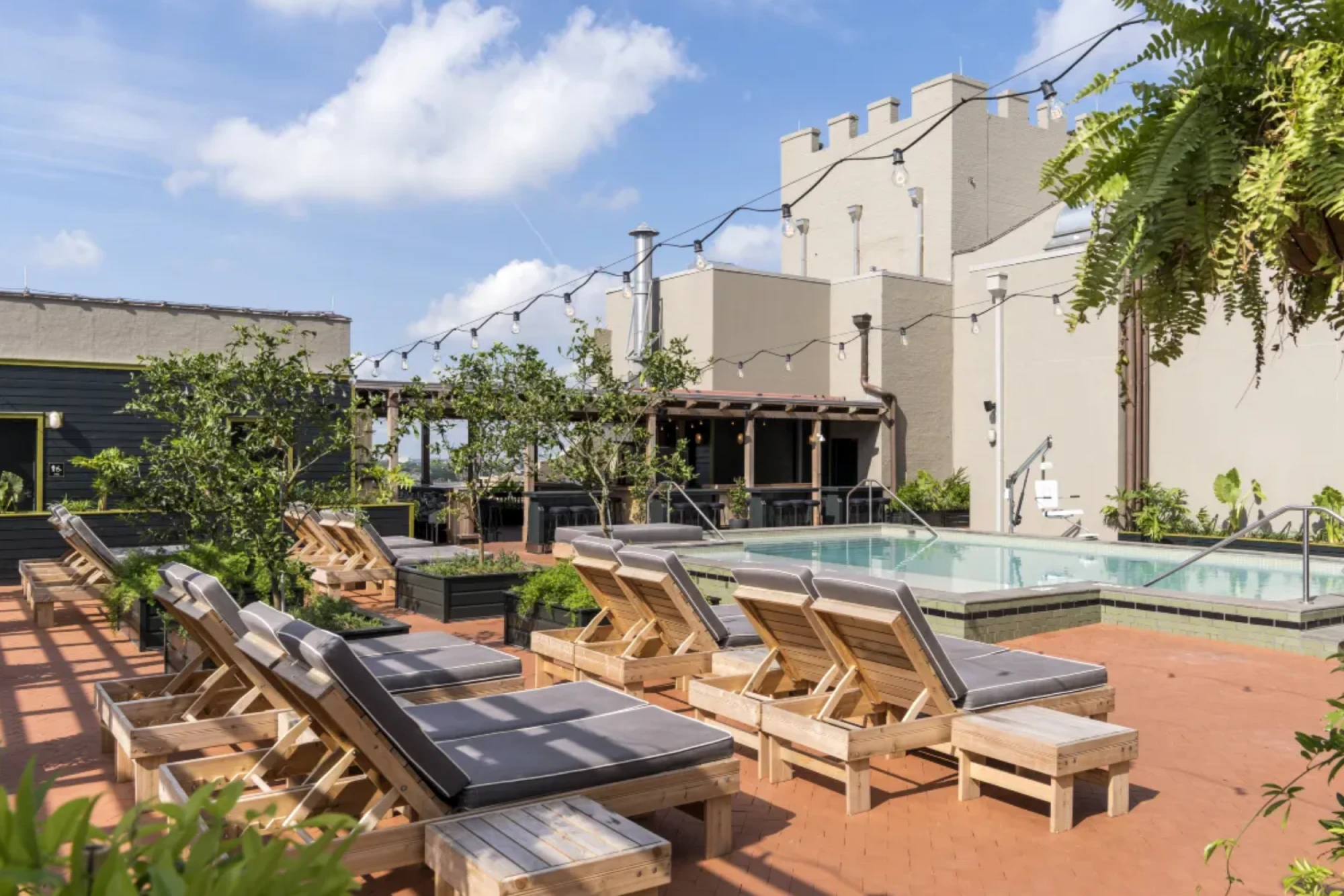 a patio with lounge chairs and a swimming pool