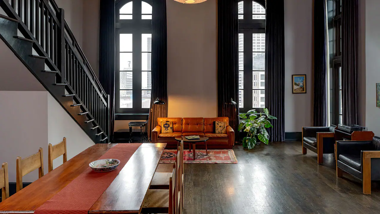 a living room filled with furniture and a staircase