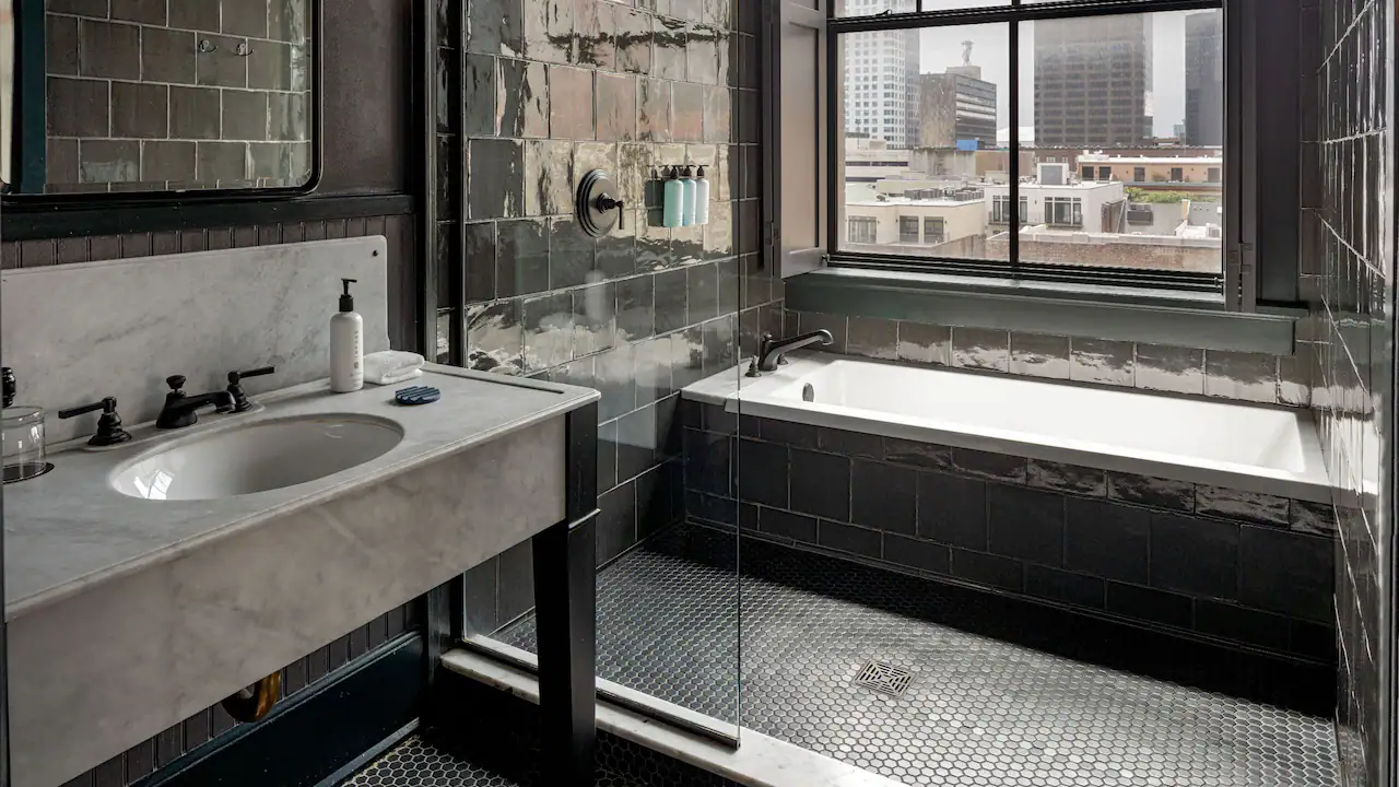 a bath room with a sink a bath tub and a window