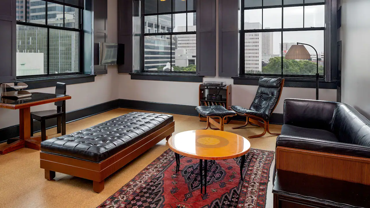 a living room filled with furniture and windows