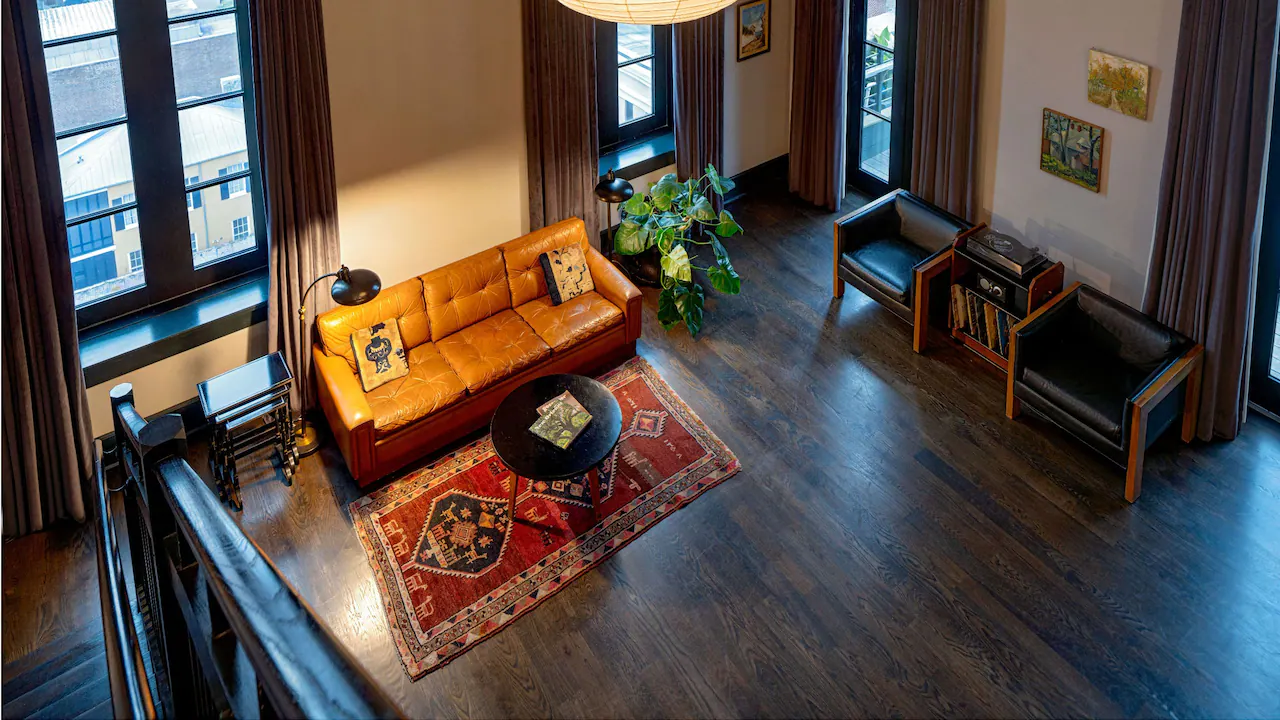 a living room filled with furniture and lots of windows