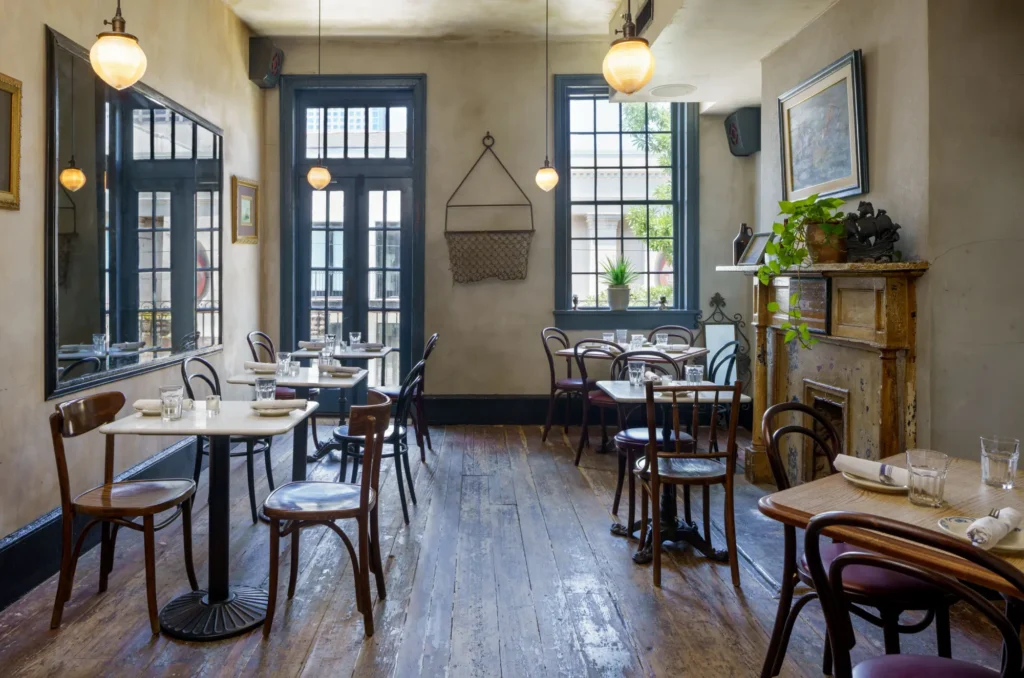 a restaurant with tables, chairs, and a fire place