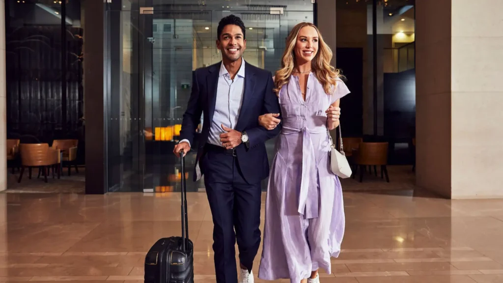 Professional shot of a happy couple checking into a modern luxury boutique hotels new orleans