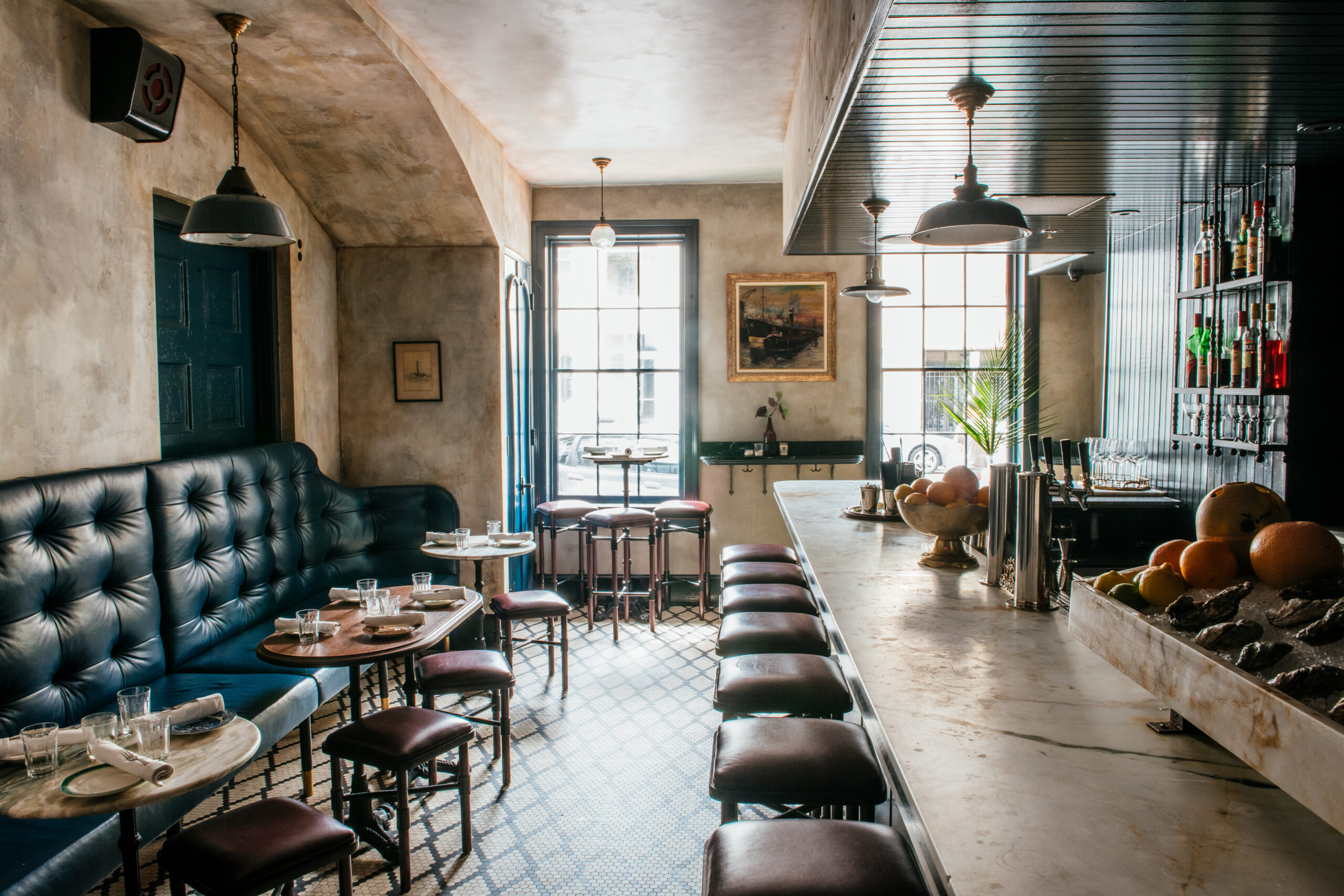 Detailed view of the luxurious bar featuring dark blue leather booths and marble counters