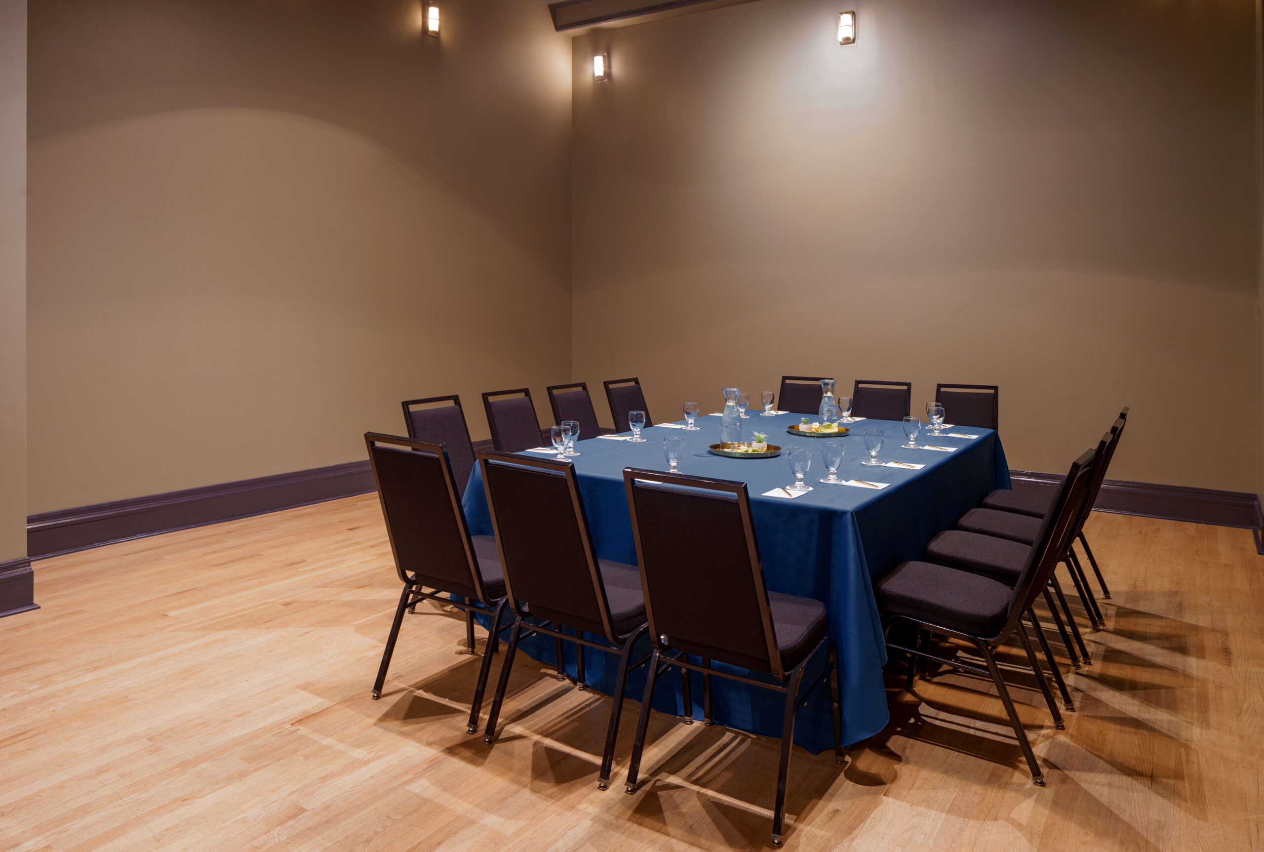 Stylish meeting room at The Barnett with 12 seats set around a large blue conference table